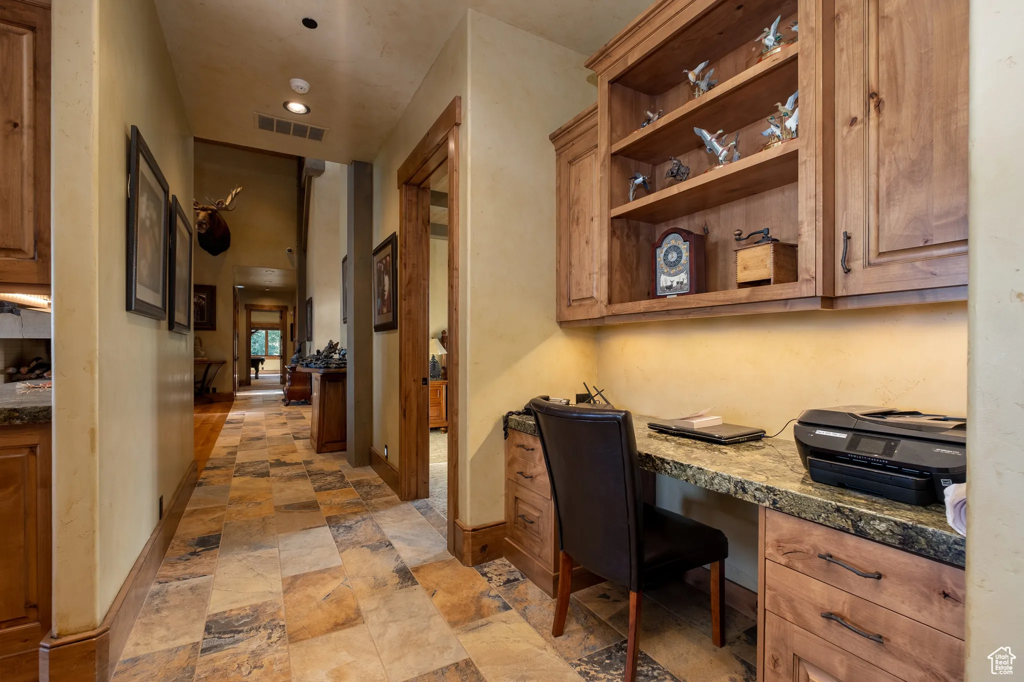 Home office with visible vents, built in study area, baseboards, recessed lighting, and stone finish flooring