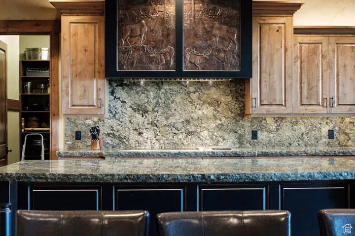 Kitchen with backsplash and dark countertops