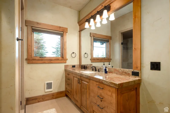 Bathroom with vanity, baseboards, and visible vents