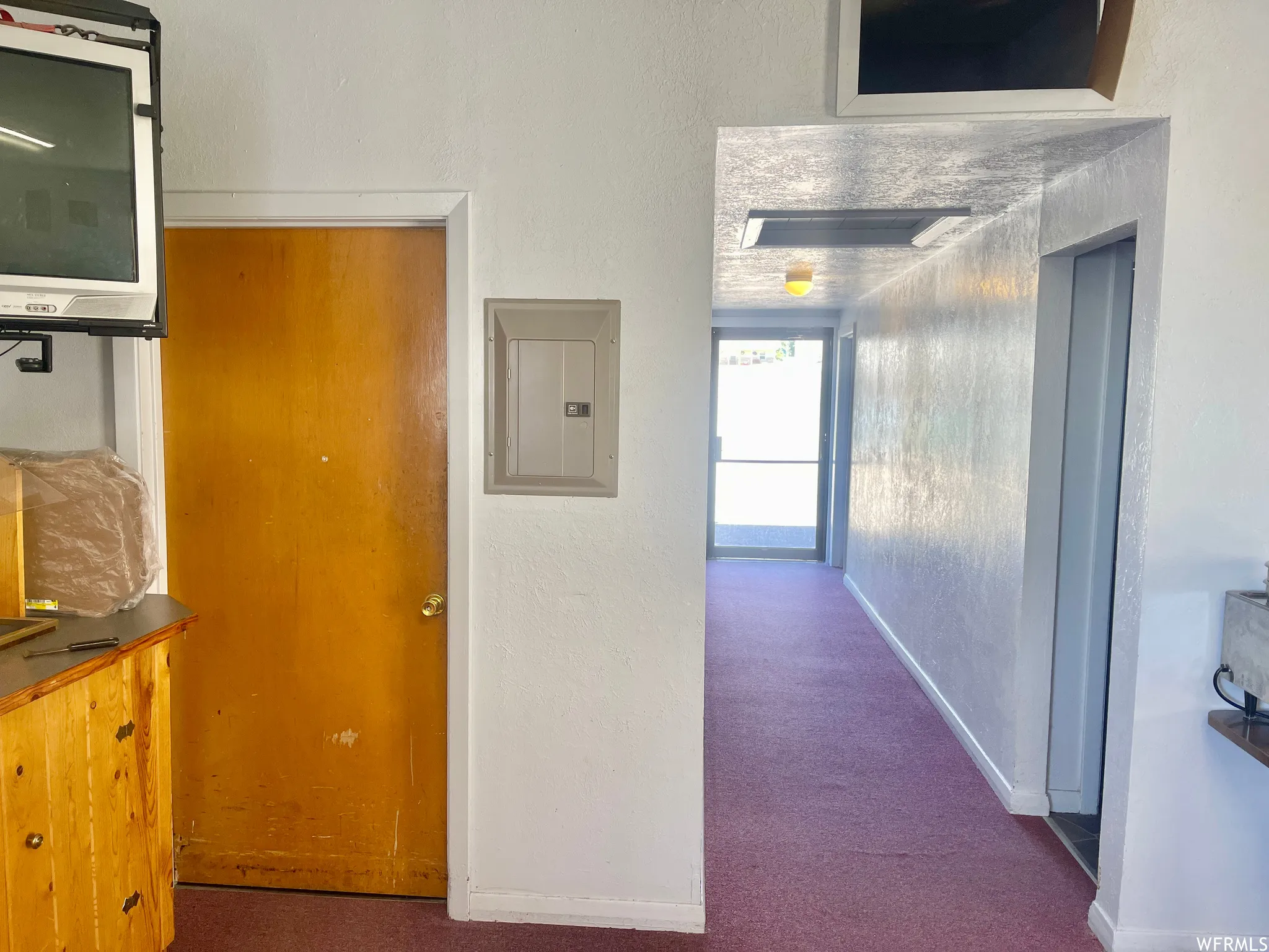 Hallway with carpet and natural light
