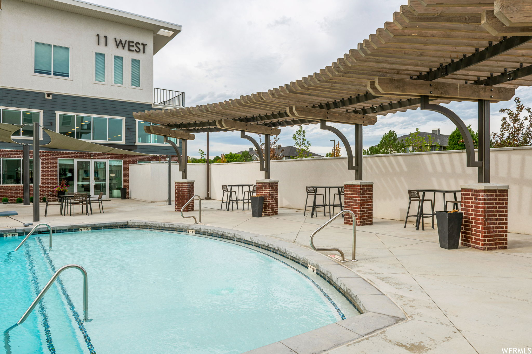 View of pool featuring a patio and a pergola
