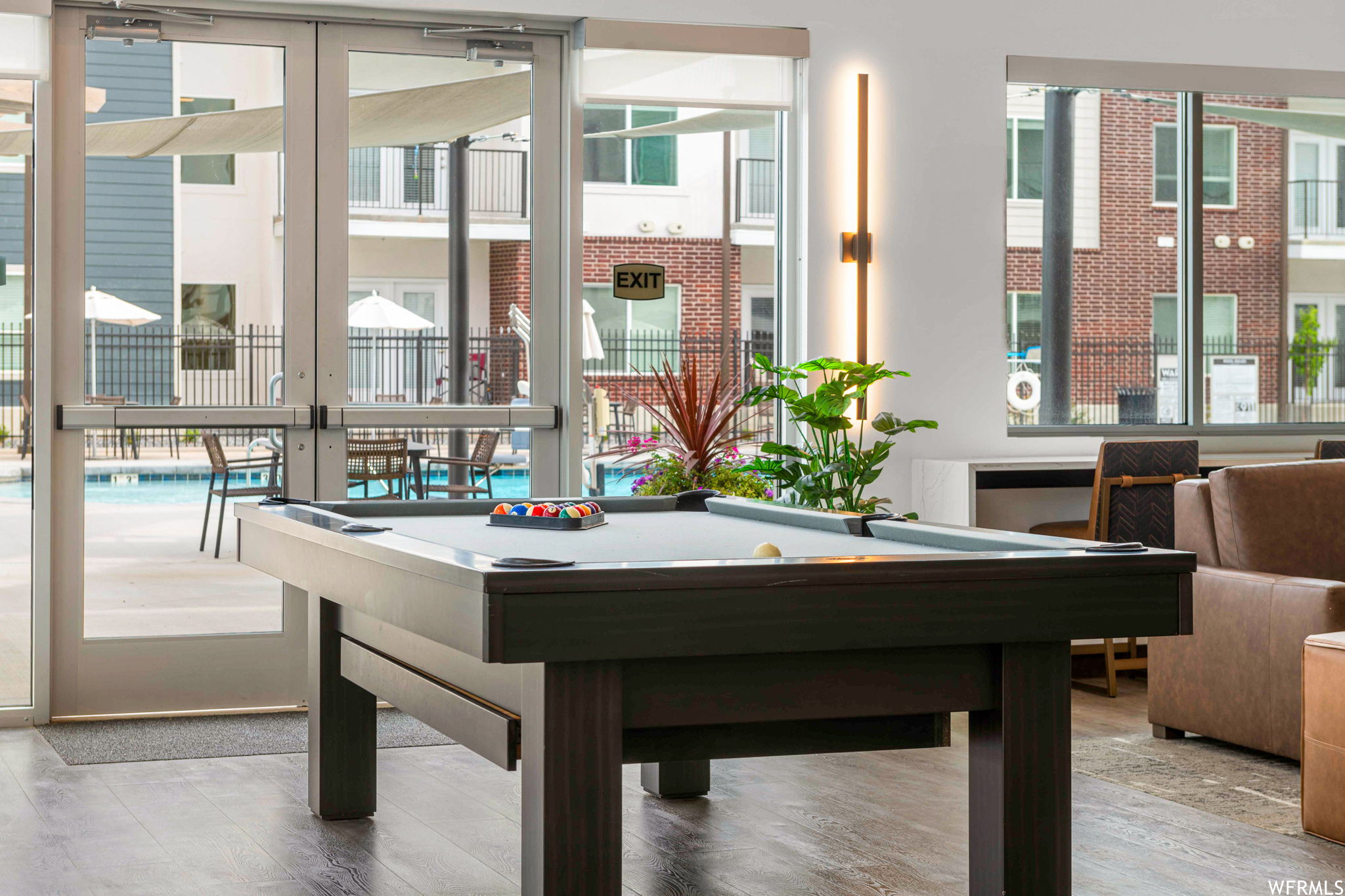 Rec room featuring a wealth of natural light and light hardwood floors