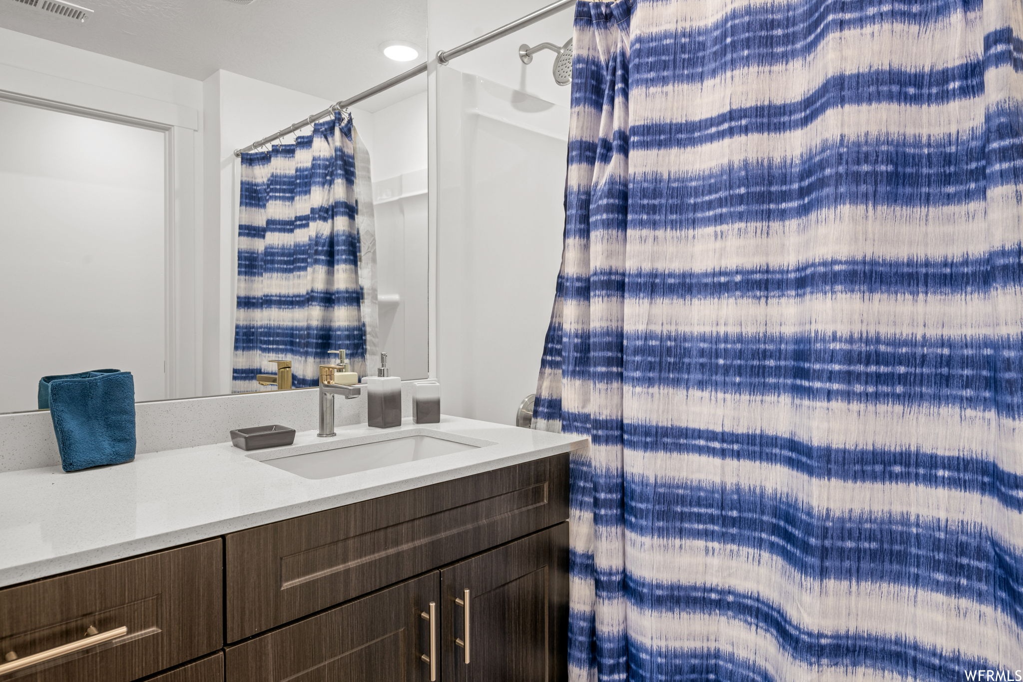Bathroom with mirror and vanity
