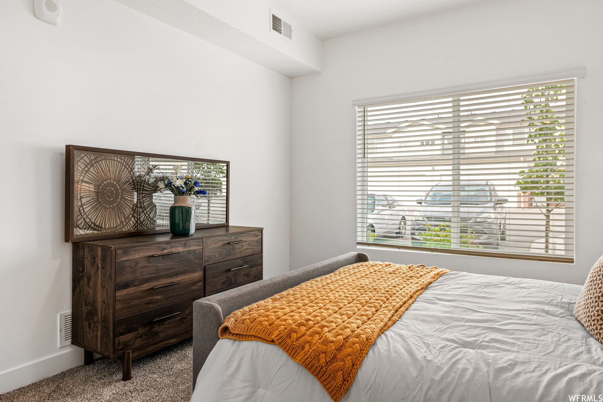 Bedroom featuring light carpet