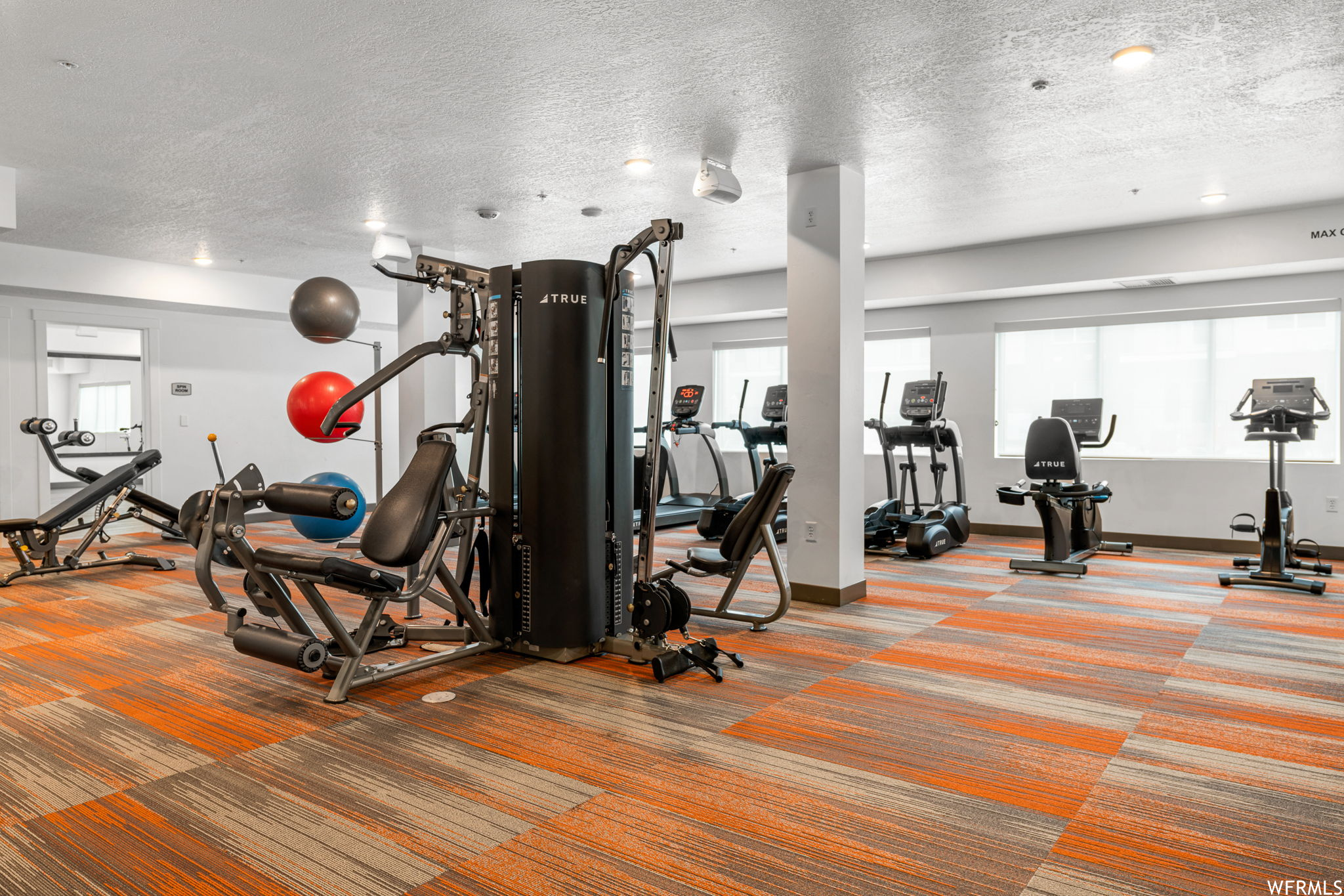 Exercise room featuring a textured ceiling
