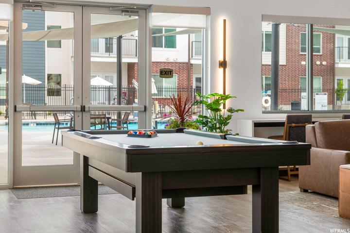 Rec room featuring a wealth of natural light and light hardwood floors