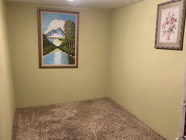 Empty room featuring carpet flooring