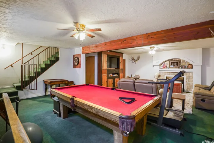 Rec room featuring billiards, ceiling fan, and a textured ceiling