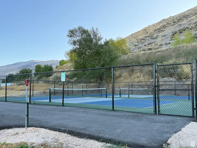 View of tennis court featuring a mountain view