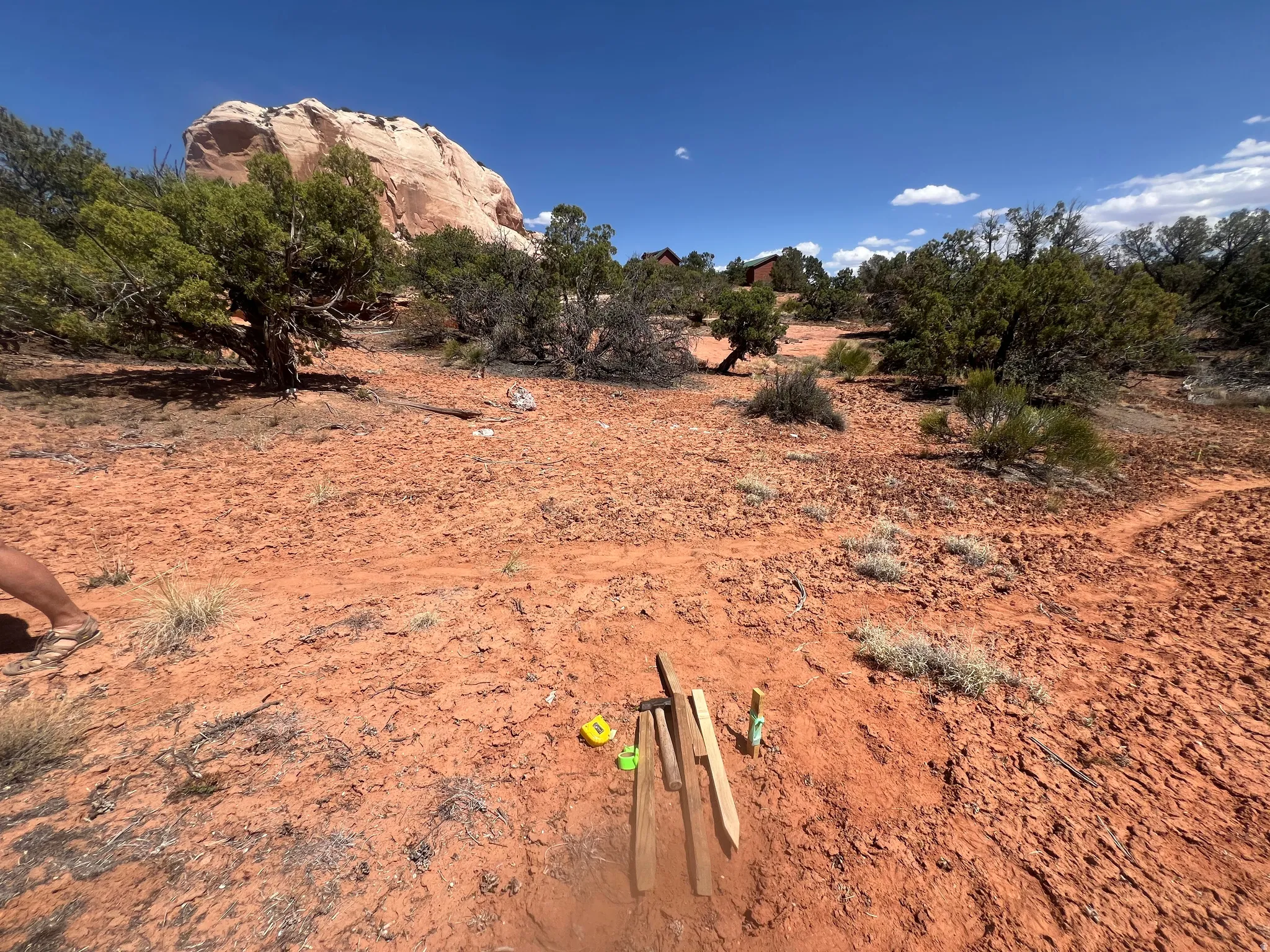 Expansive undeveloped land featuring natural terrain and distant rock formations