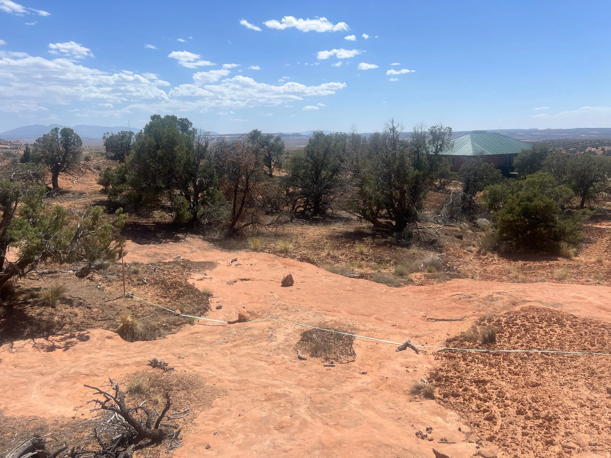 Expansive land parcel featuring natural rock formations and established trees