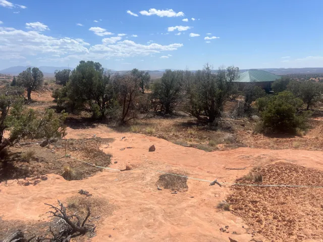 Expansive land parcel featuring natural rock formations and established trees