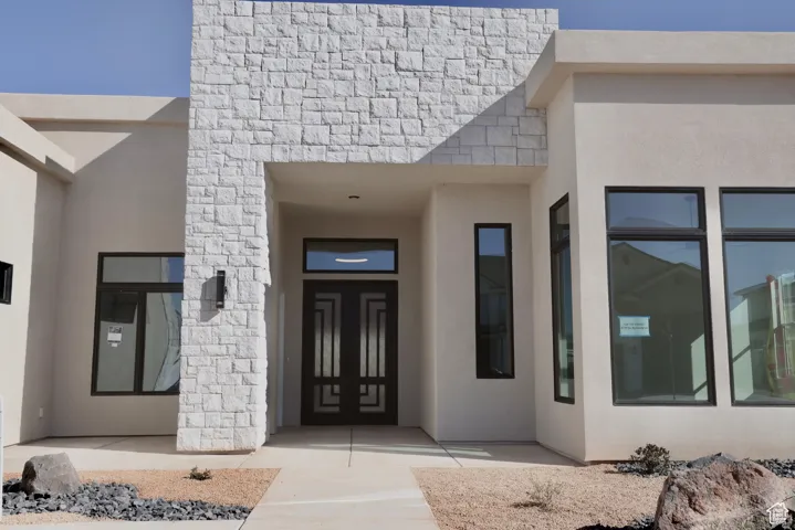 View of exterior entry featuring stucco siding