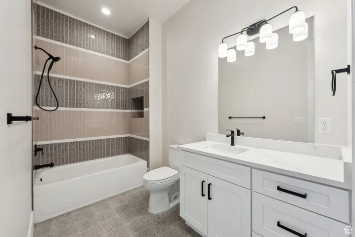 Bathroom with vanity, bathing tub / shower combination, and toilet