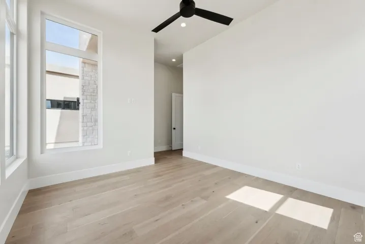 Unfurnished room featuring a ceiling fan, baseboards, recessed lighting, and light wood-style floors