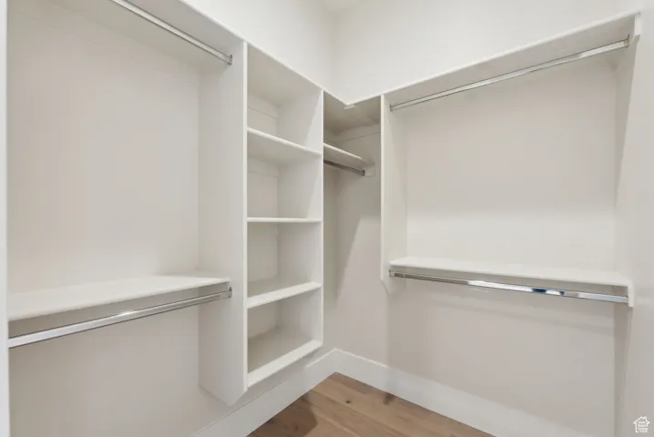 Walk in closet featuring wood finished floors
