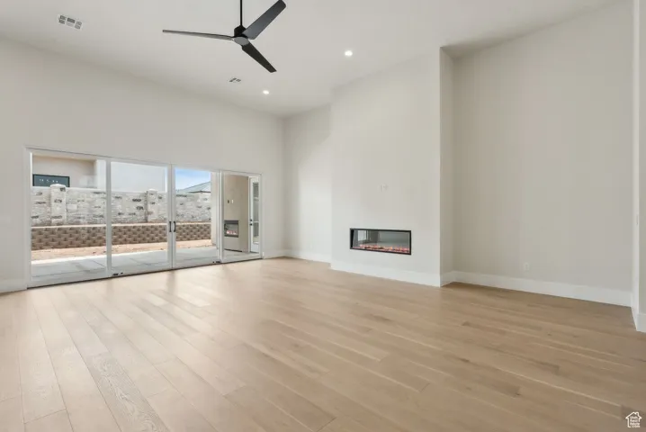 Unfurnished living room with ceiling fan, light wood-style floors, recessed lighting, baseboards, and visible vents