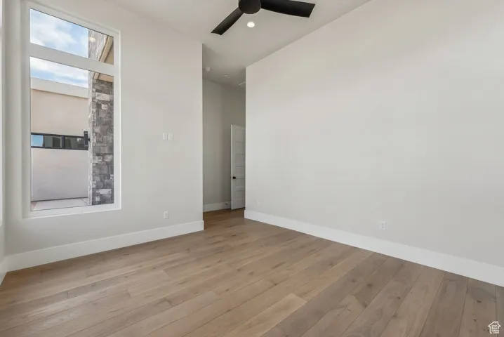 Spare room featuring light wood-style floors, baseboards, a ceiling fan, and recessed lighting