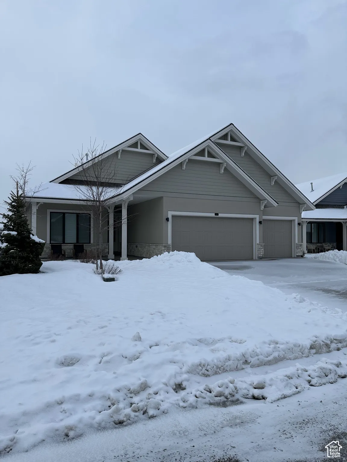 View of front facade with stone siding and an attached garage