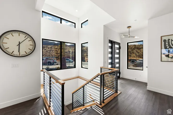 Stairs with dark hardwood / wood-style floors