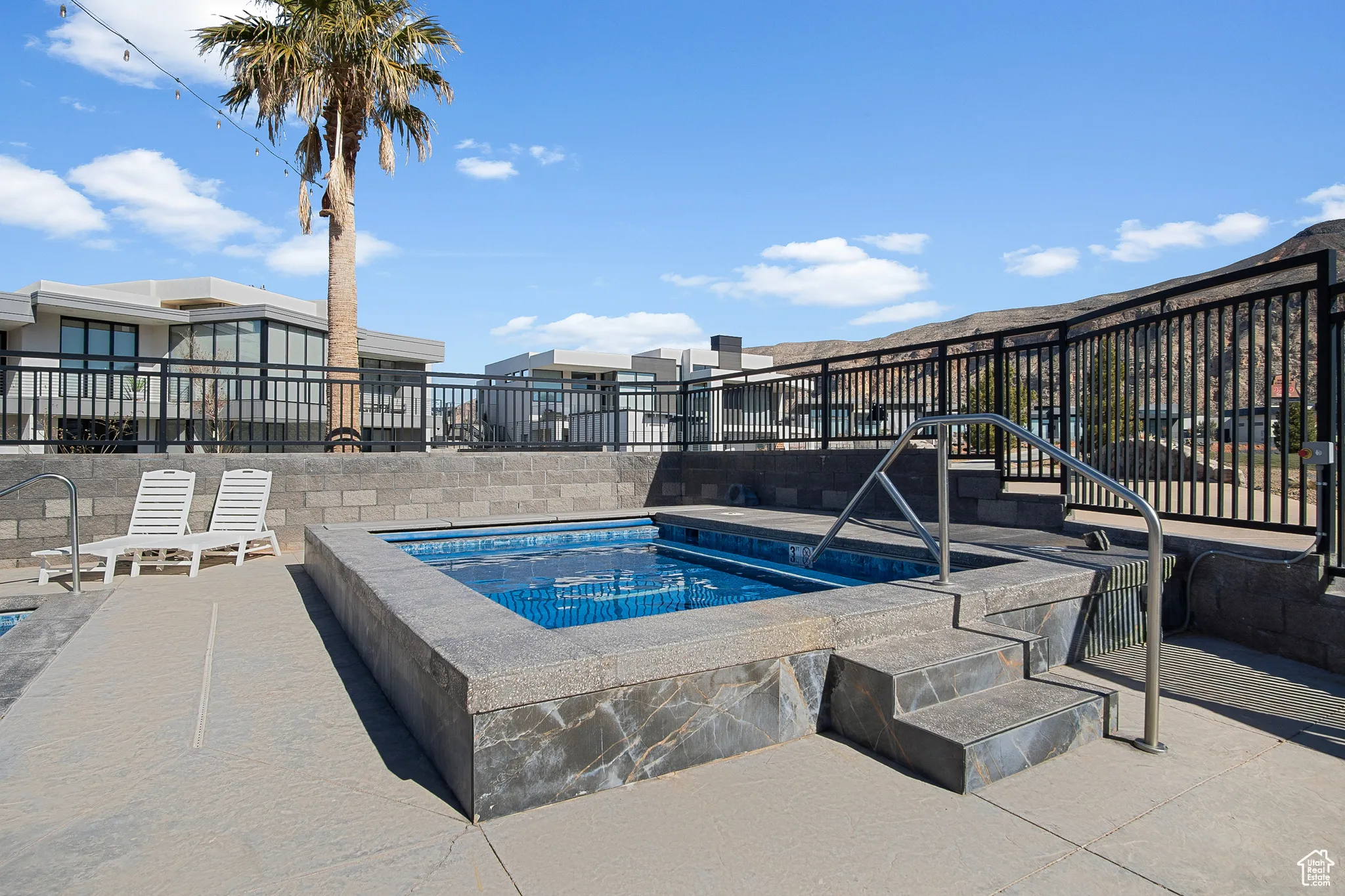 View of pool featuring a hot tub and a patio