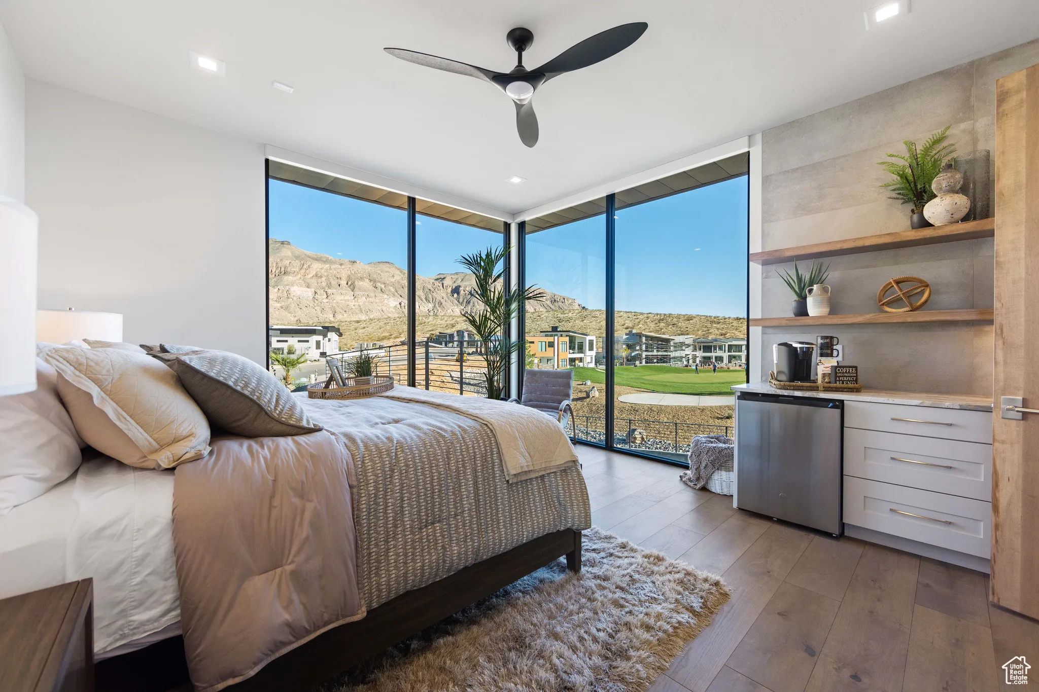 Bedroom with floor to ceiling windows, light hardwood / wood-style flooring, ceiling fan, access to exterior, and fridge