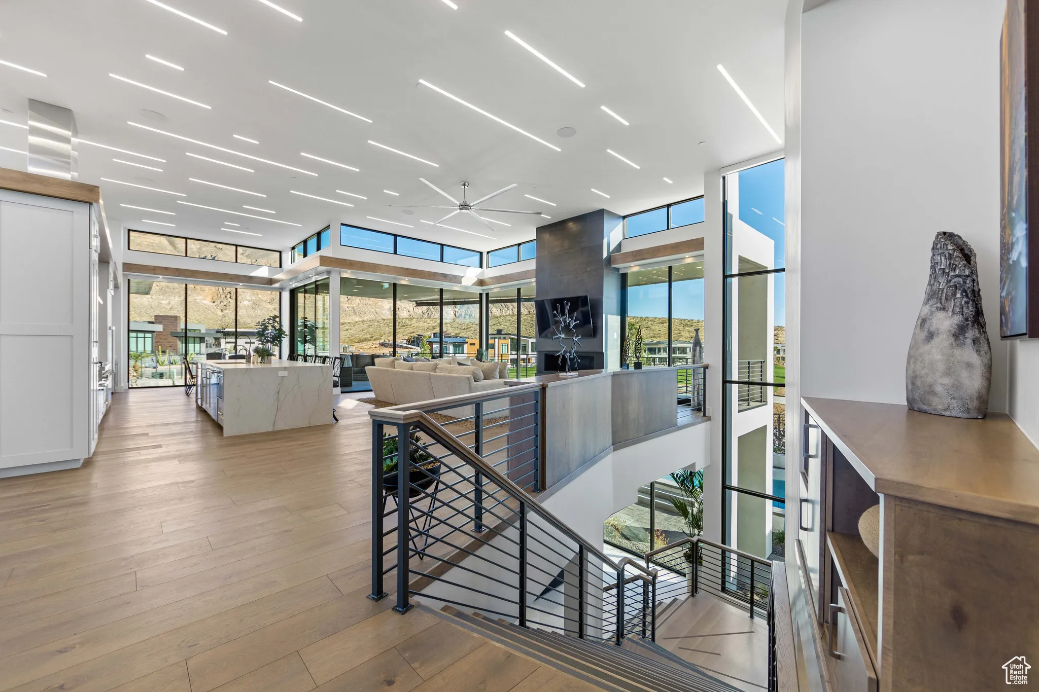 Corridor featuring floor to ceiling windows, light hardwood / wood-style flooring, and plenty of natural light
