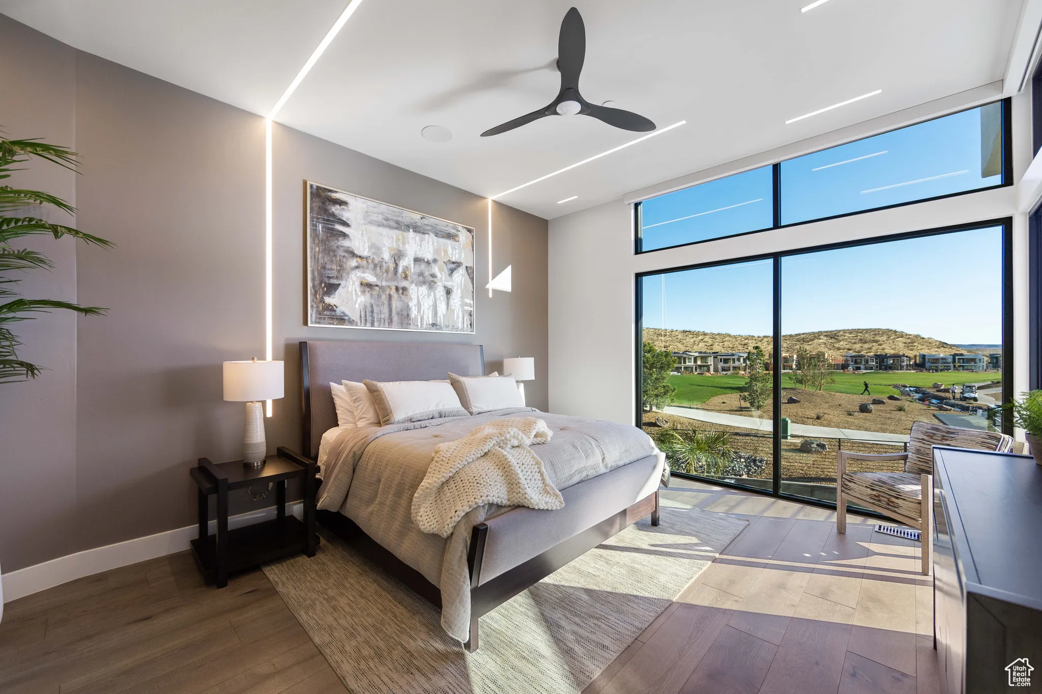 Bedroom with hardwood / wood-style floors, ceiling fan, and access to exterior