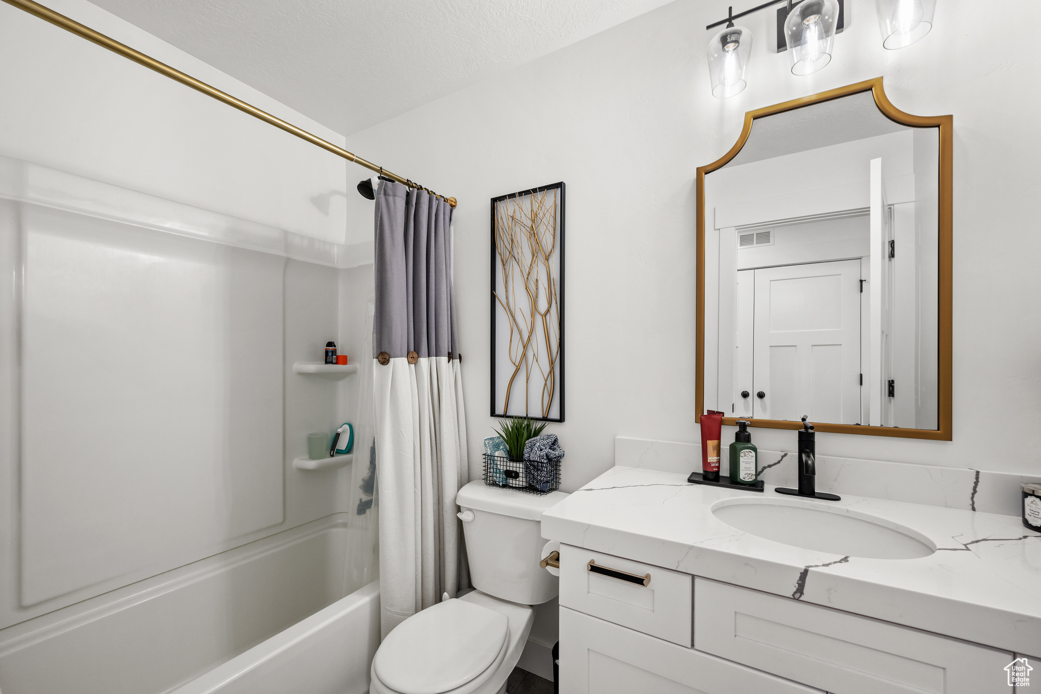 Full bathroom featuring shower / tub combo, large vanity, and toilet