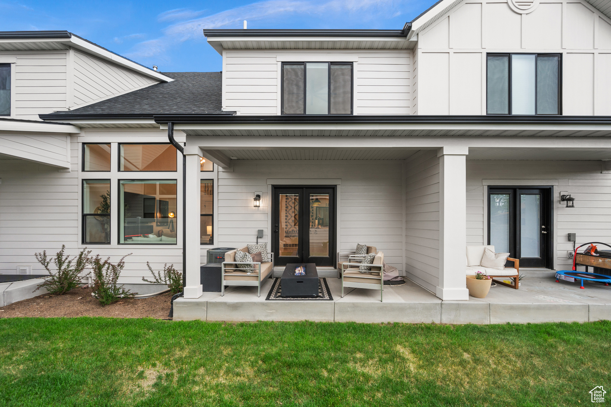 Back of property with a yard, a patio area, outdoor lounge area, and french doors