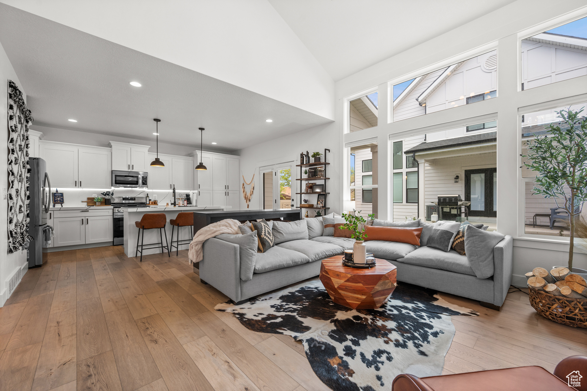 Living room featuring light hardwood / wood-style floors and high vaulted ceiling
