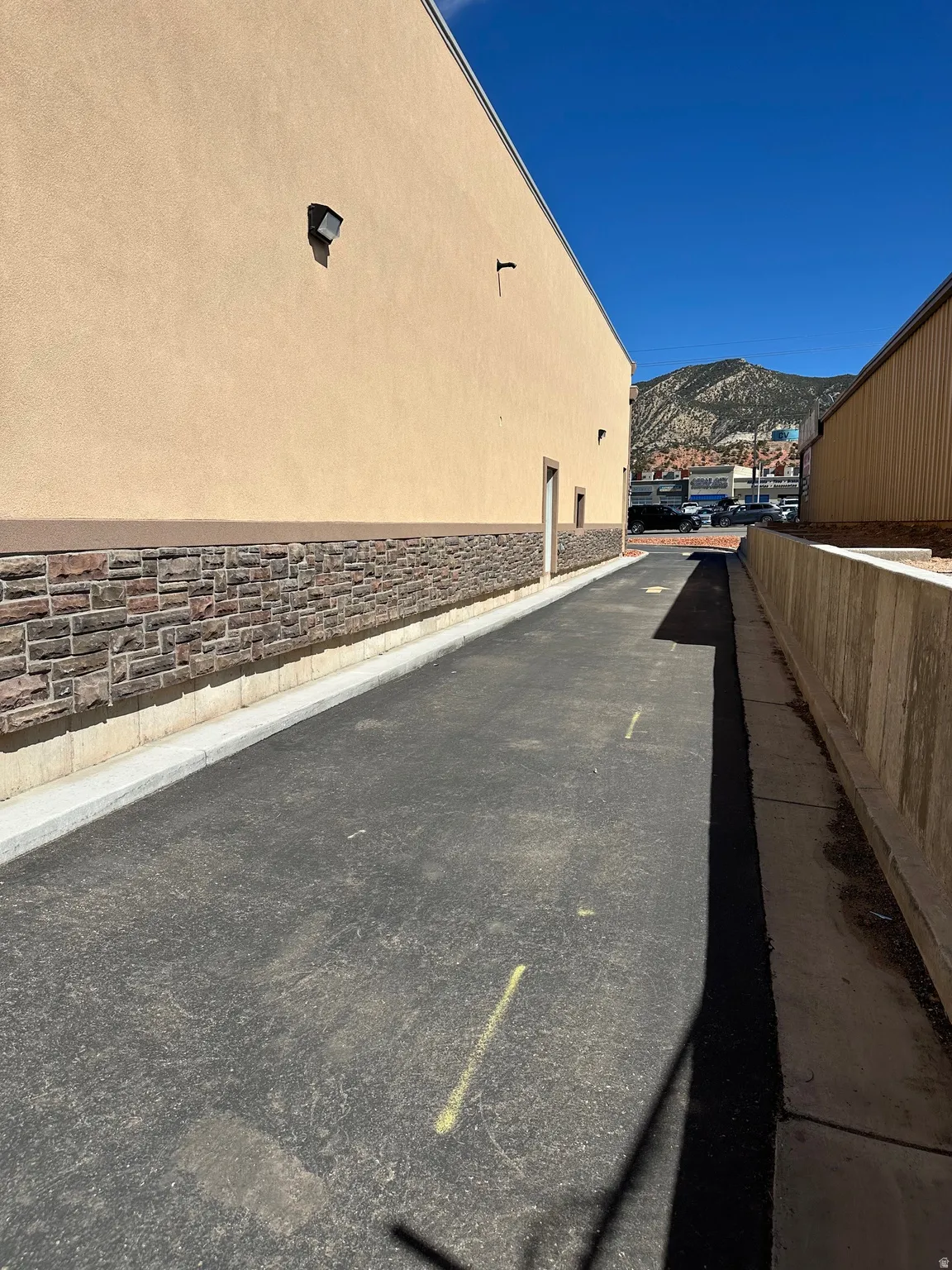 View of property exterior featuring a mountain view and stone siding