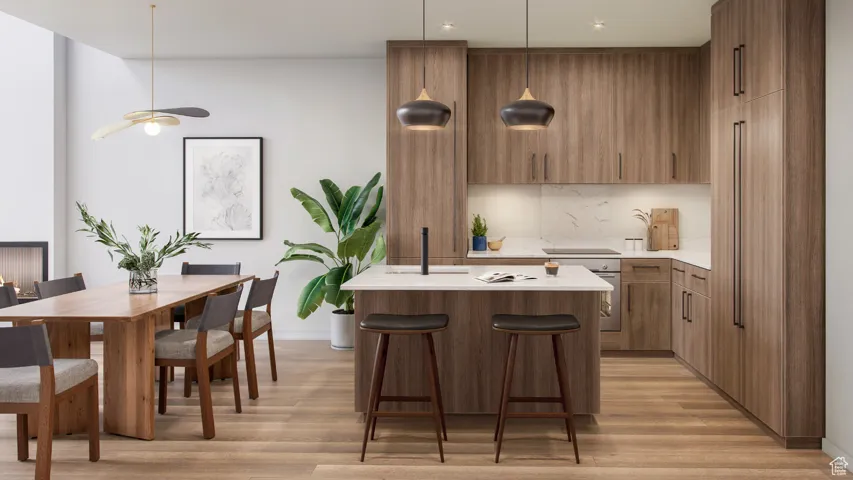 Kitchen featuring a kitchen island, pendant lighting, light wood-type flooring, and ceiling fan