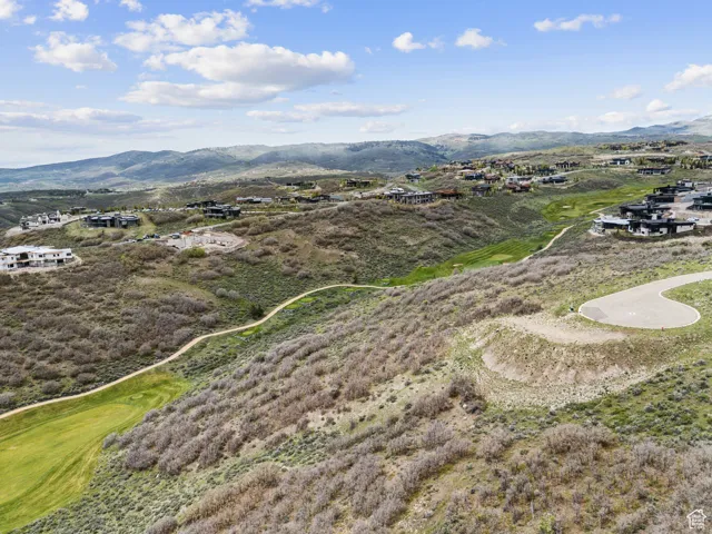 Bird's eye view of a mountain backdrop and a golf course