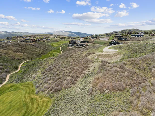 Aerial view of property's location with a mountain backdrop