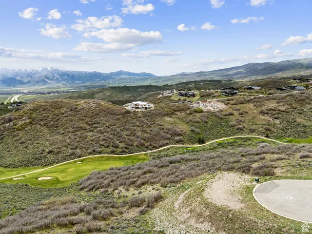 Drone / aerial view of a mountainous background and a local golf course