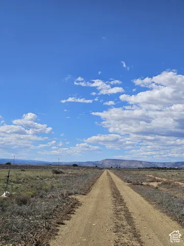 Expansive natural landscape with a clear sky and distant mountains