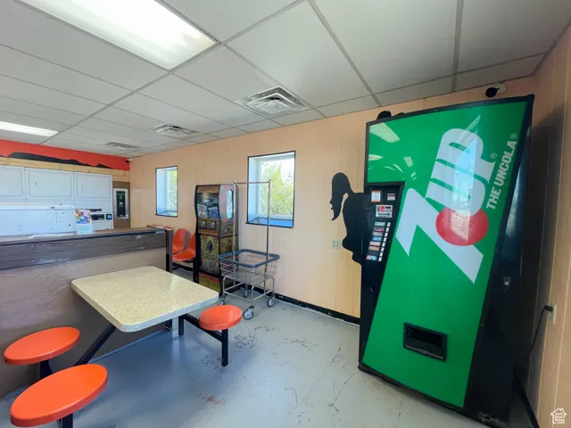 Interior space with a drop ceiling and concrete flooring