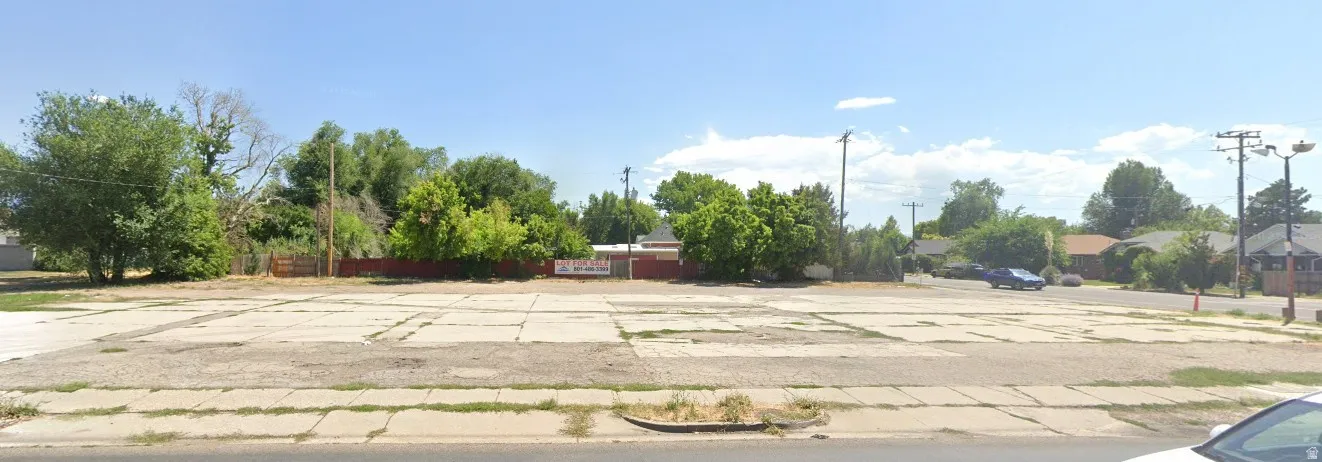 Expansive lot with existing paved surfaces and mature perimeter trees