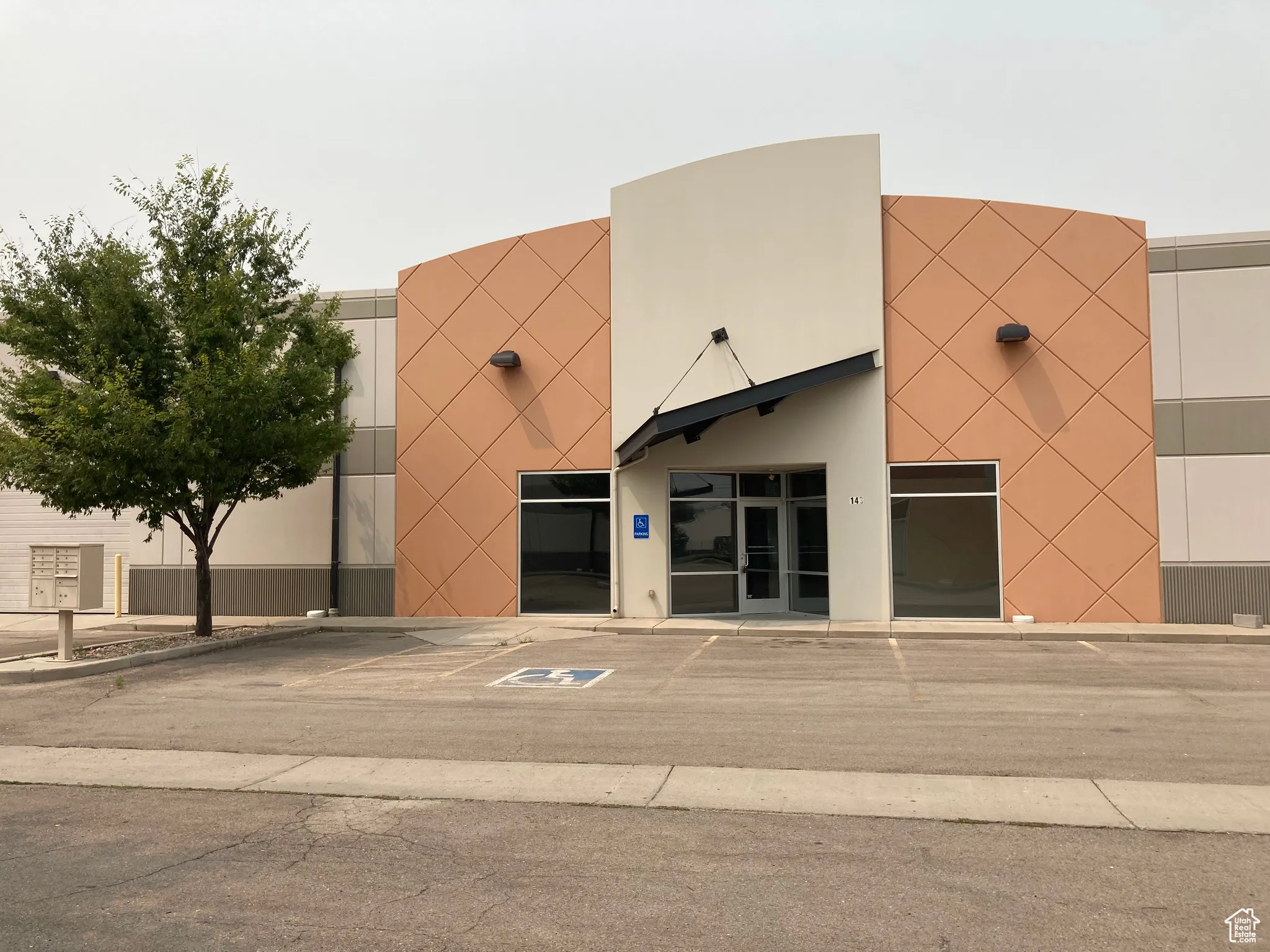 View of building exterior with uncovered parking