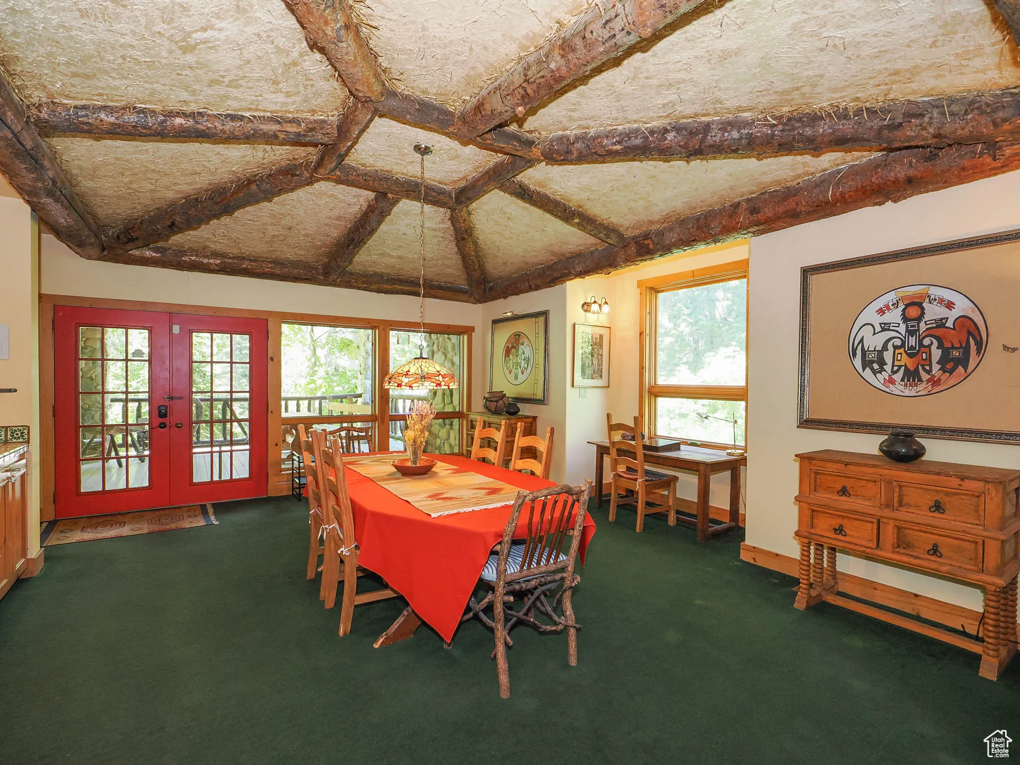 Dining room featuring natural light, coved plaster & straw ceiling with log pattern