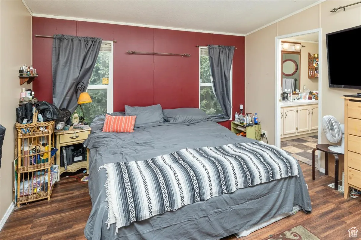 Unit A: Master Bedroom featuring dark hardwood / wood-style floors, and ensuite bath