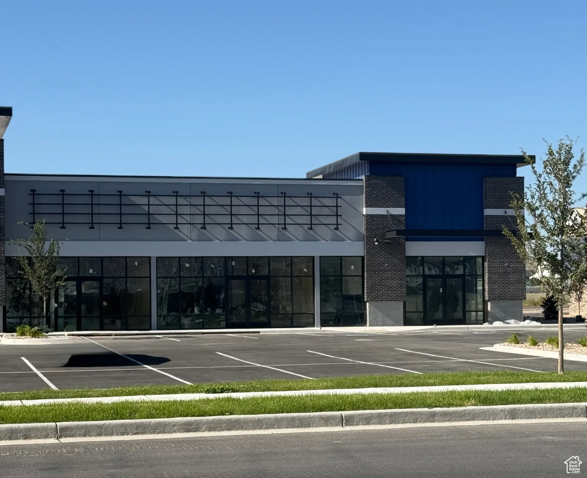 View of commercial property with uncovered parking