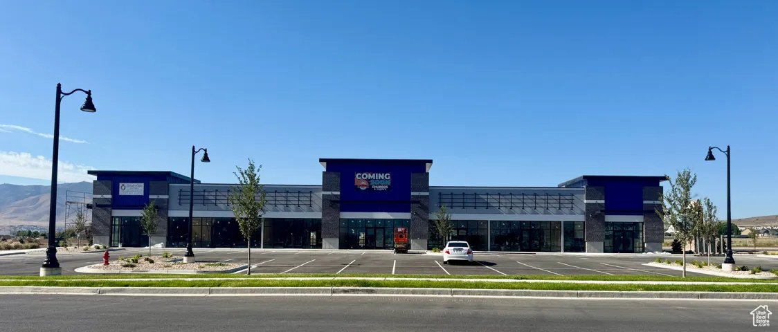 View of commercial location featuring uncovered parking and a mountain view