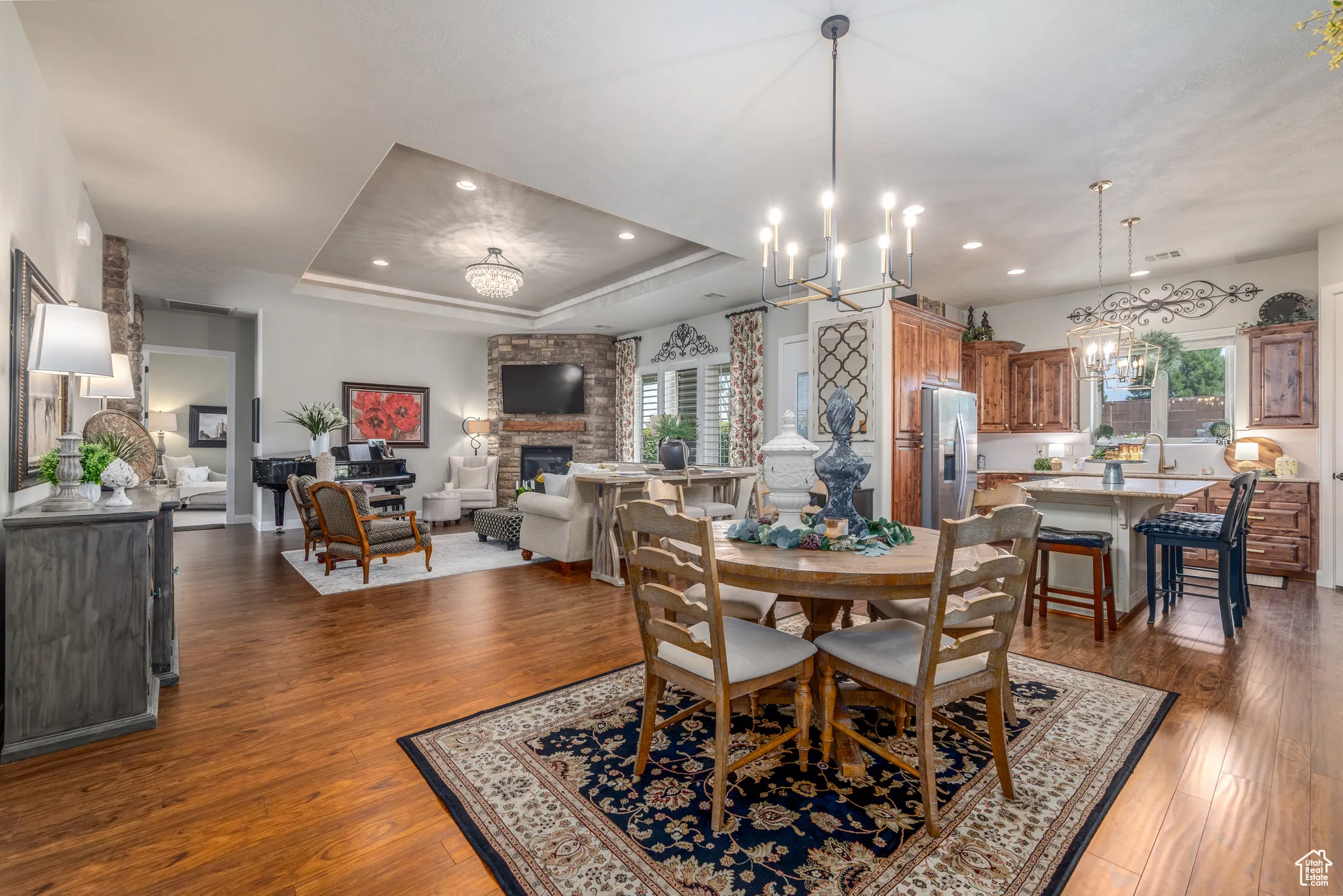 Dining area featuring plenty of natural light, dark wood-type flooring, and a tray ceiling