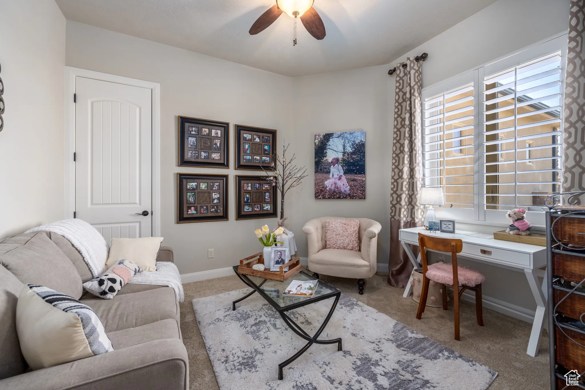 Living room featuring carpet and ceiling fan