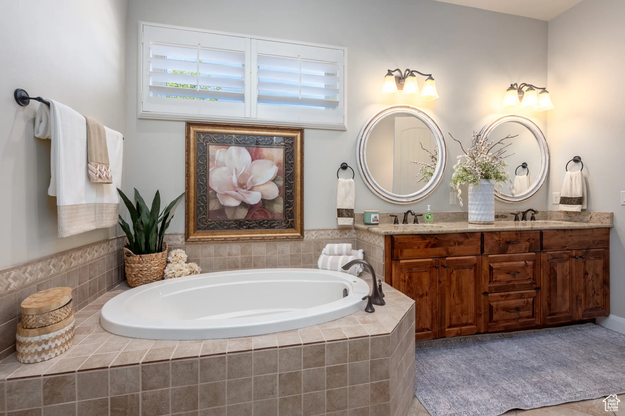Bathroom with a relaxing tiled tub and double vanity