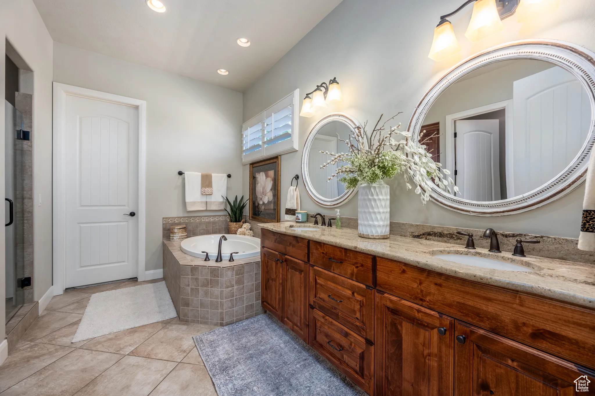 Bathroom with independent shower and bath, tile patterned flooring, and dual bowl vanity