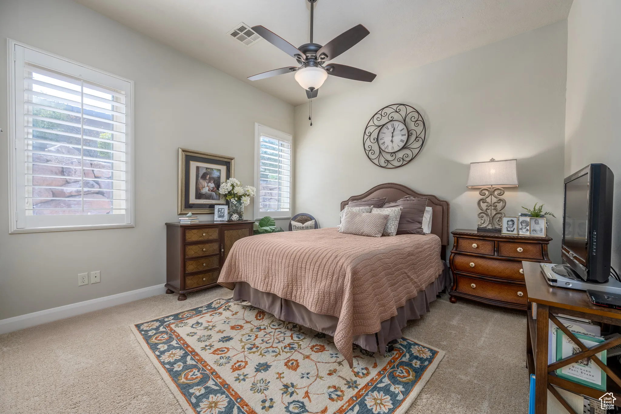 Carpeted bedroom featuring ceiling fan