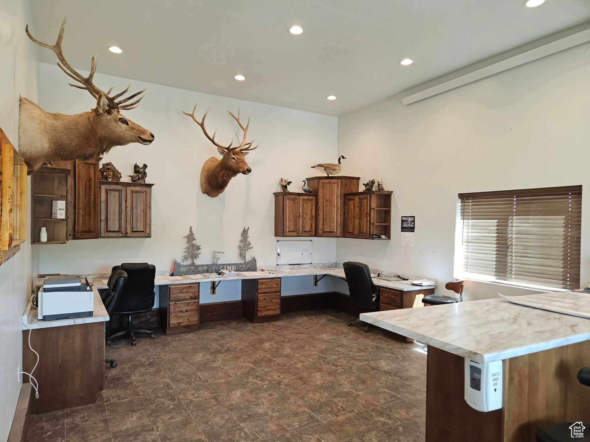 Office area featuring built in desk and recessed lighting